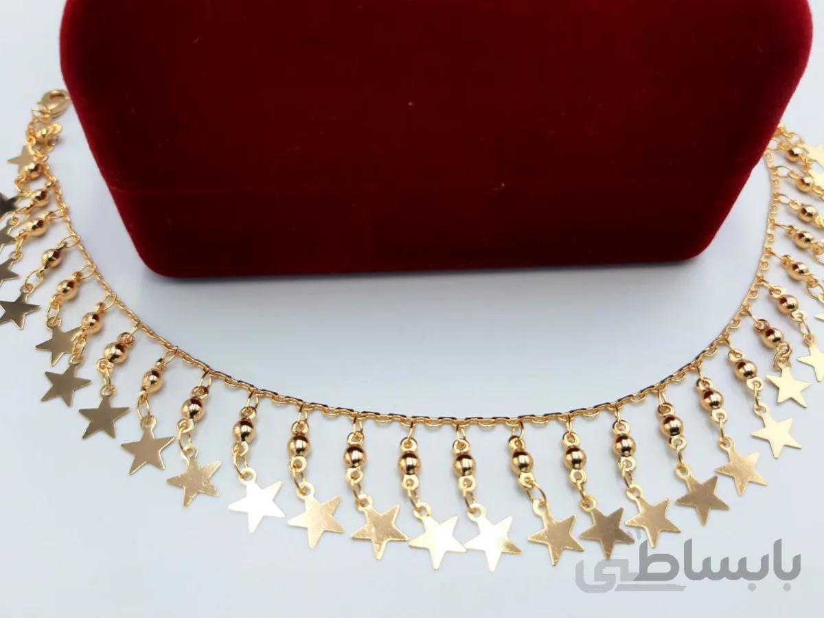 پابند با آویزهای ستاره پرکار طلایی