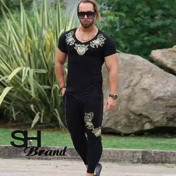 ست مردانه تیشرت و شلوار طرح گل طلایی رنگ مشکی کد172 ا Men's set of T-shirt and pants with black flower design, code 172