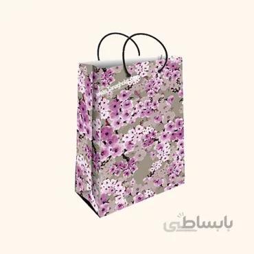 ساک کادویی متوسط طولی سایز 3 طرح گل بنفش با زمینه طوسی