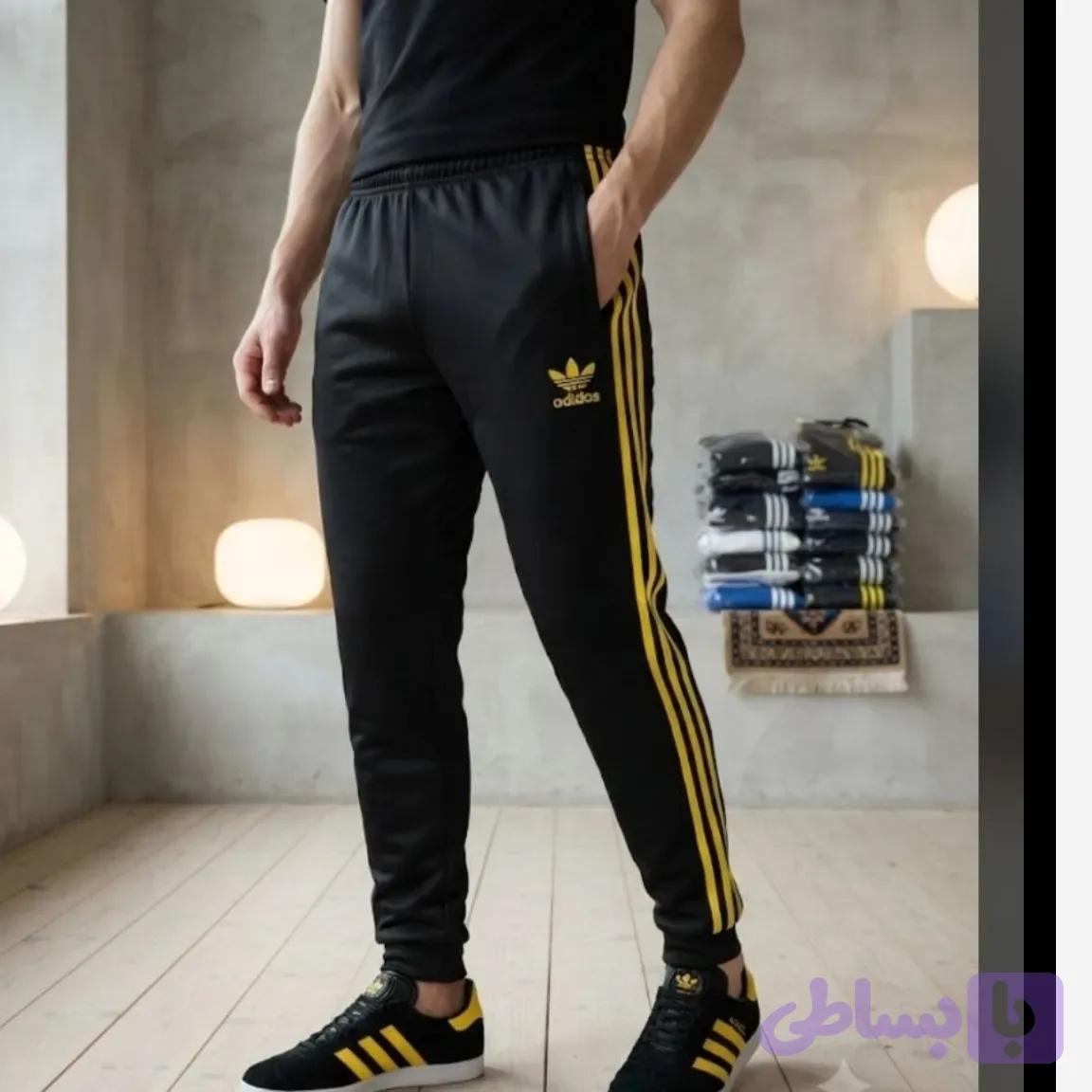 شلوار اسلش مردانه مدل آدیداس سه خط زرد رنگ مشکی جنس پارچه زهره درجه یک دمپا کش